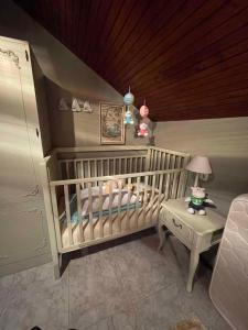 a baby room with a crib and a table at Holiday Homes in Matulji 15676 in Matulji