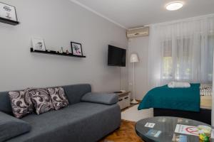 a living room with a couch and a table at Vikendica Julka Palić in Palić