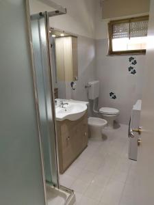 a bathroom with a sink and a toilet at Beach House, 300 m dal mare, Marina di Massa in Marina di Massa +34 photos