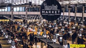 a large crowd of people in a large building at Chiado Open World Hostel in Lisbon