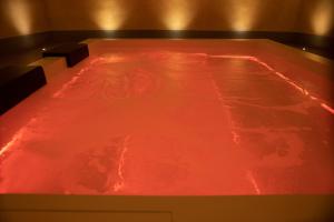 a hot tub with red water in a room at Regina Bianca - Camere, Suite & Spa - Sciacca in Sciacca
