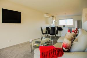 a living room with a white couch and a table at Tekapo Luxury Apartments in Lake Tekapo