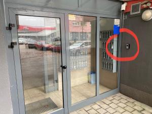 a glass door with a red circle on it at Bizi Green - Zagreb South in Zagreb