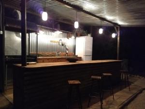 a kitchen with a counter and stools in a room at Romantic Safari tent in Tortosa
