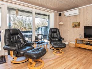two leather chairs and a table in a living room at 6 person holiday home in Hemmet in Falen