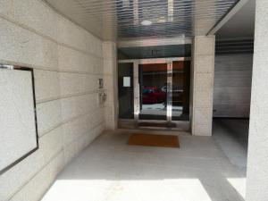 an empty hallway in a building with a glass door at Mi humilde morada in Redondela