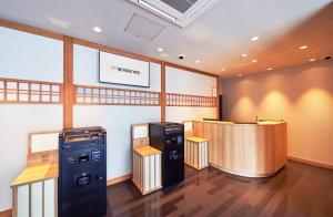 a fast food restaurant with a bar and a cash register at THE POCKET HOTEL Kyoto Karasuma Gojo in Kyoto