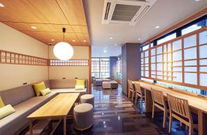 a restaurant with tables and chairs and windows at THE POCKET HOTEL Kyoto Karasuma Gojo in Kyoto