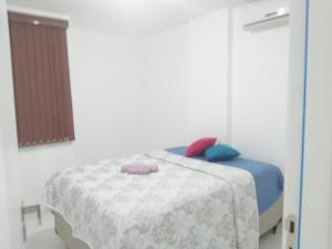 a bedroom with a bed with a table and a window at Intermares na melhor localização in Cabedelo +27 photos