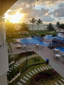 a view of a swimming pool at a resort at MAUÍ BEACH RESIDENCE - Beira-mar Tamandaré- Próximo a Igreja de São Pedro- PE in Tamandaré