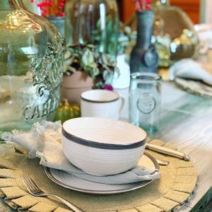 a table with a bowl and plates on a table at Vida Boutique Inn in Worcester