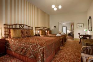 a hotel room with two beds in a room at Hadley's Orient Hotel in Hobart