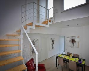 a staircase in a house with a table and a dining room at L'Affaccio in Matera