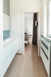 a white bathroom with a sink and a mirror at FeMa B&B - Housea in Polignano a Mare +19 photos
