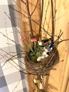 a bird nest on a wall with rocks and flowers at Antjes kleines Nest in Tröstau