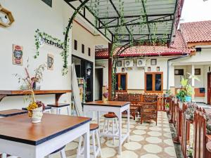 a patio of a restaurant with tables and chairs at OYO 2835 Sakinah Family Residence in Tulungagung