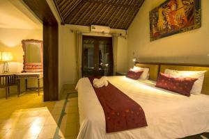 Postel nebo postele na pokoji v ubytování Bebek Cottages Sanur