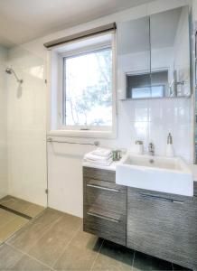 a bathroom with a sink and a window at 10 Maisonettes in Falls Creek