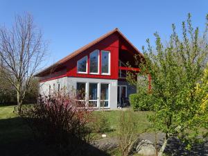 a red and white house with a red roof at Ferienhaus Ostseeblick in Hohen Schönberg