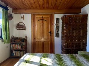 a bedroom with a bed and a wooden door at Małanka - kaszubska chëcz in Strzepcz