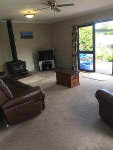 a living room with a couch and a tv at Terrific house on totara drive in Twizel