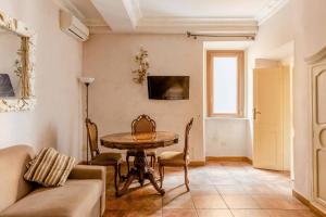a living room with a table and a couch at Rome right in the ancient historical center two bedrooms two bath, Up to 6 pax in Rome