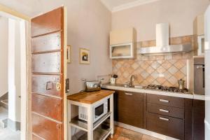 a kitchen with a sink and a microwave at Rome right in the ancient historical center two bedrooms two bath, Up to 6 pax in Rome