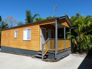 a tiny house with a porch on a street at Charters Towers Tourist Park in Charters Towers