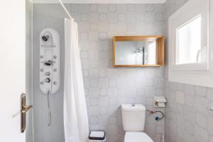 a bathroom with a white toilet and a mirror at Cala Serena Beach 5 in Felanitx +17 photos