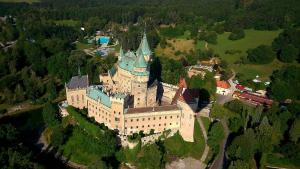 an aerial view of a castle with a blue roof at Penzión DRUŽBA Bojnice in Bojnice