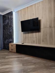 a living room with a flat screen tv on a wall at Apartment on Bohdana Havrylyshyna in Kyiv