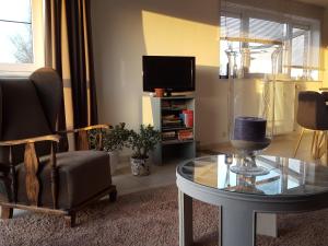 - un salon avec une table en verre et une télévision dans l'établissement Apartment Nathalie, à Comines