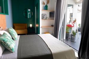 a bedroom with a bed and a green wall at Curù in Castellammare del Golfo