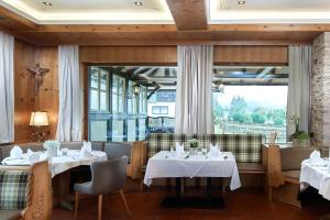 a restaurant with two tables and a large window at Gasthof Post St. Martin am Tgb. in Sankt Martin am Tennengebirge