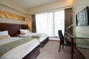 Llit o llits en una habitació de Brighton Hotel Hong Kong