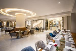 a restaurant with couches and tables and chairs at Al Mashreq Boutique Hotel - Small Luxury Hotels of the World in Riyadh