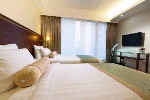 Llit o llits en una habitació de Brighton Hotel Hong Kong