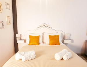 a bedroom with a bed with two towels on it at Palace-House Hércules 92 in Seville