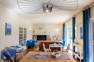 a living room with blue furniture and a large ceiling at Ty Menez in Fouesnant