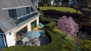 an overhead view of a house with a table and an umbrella at Ty Menez in Fouesnant