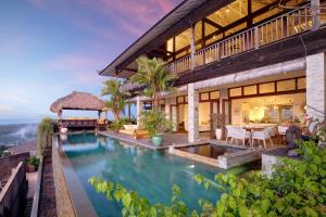 an exterior view of a villa with a swimming pool at Hidden Hills Villas - Small Luxury Hotels of The World in Uluwatu