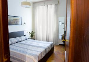 Una cama o camas en una habitación de GH Colosseum