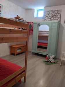 a bedroom with two bunk beds and a mirror at Le cabinet de curiosités in Aiguèze