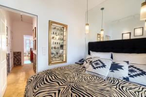 a bedroom with a large bed and a large mirror at ackselhaus & blue Home in Berlin