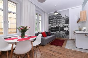 a living room with a table and a couch at Apartamenty na Starówce in Bydgoszcz