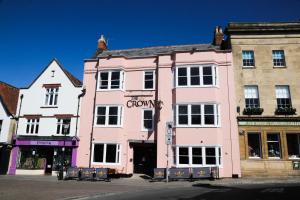 a pink building on the corner of a street at The Crown Hotel in Glastonbury