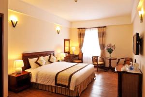 Phù Cát的住宿－Hotel Phương Anh，酒店客房带一张床、一张桌子和椅子