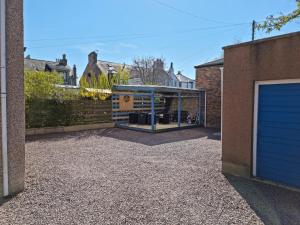 a house with a glass door and a garage at Drumdale Bed and Breakfast in Inverness