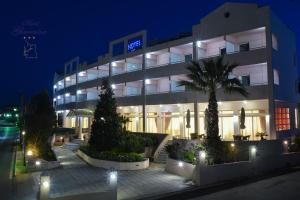 a building with a palm tree in front of it at GLARENTZA in Kyllini