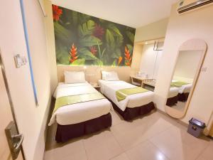 Postel nebo postele na pokoji v ubytování D'Bamboo Suites